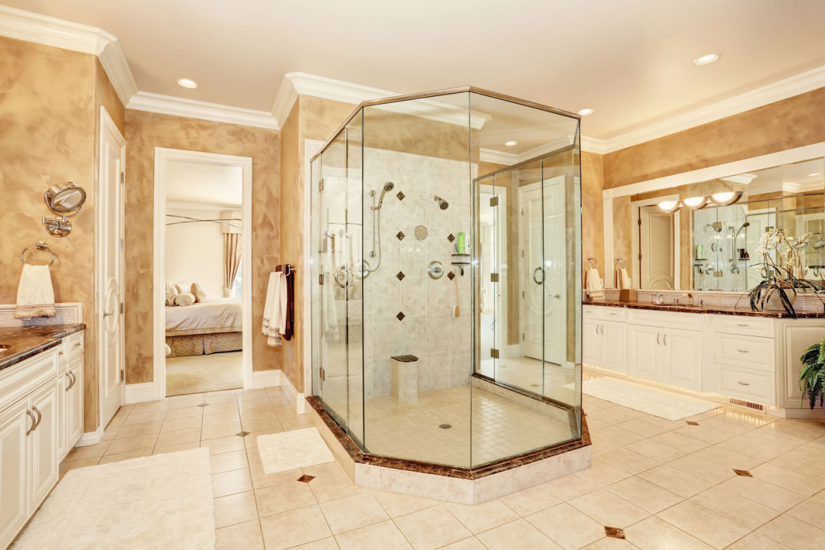 A glass shower in a large bathroom.